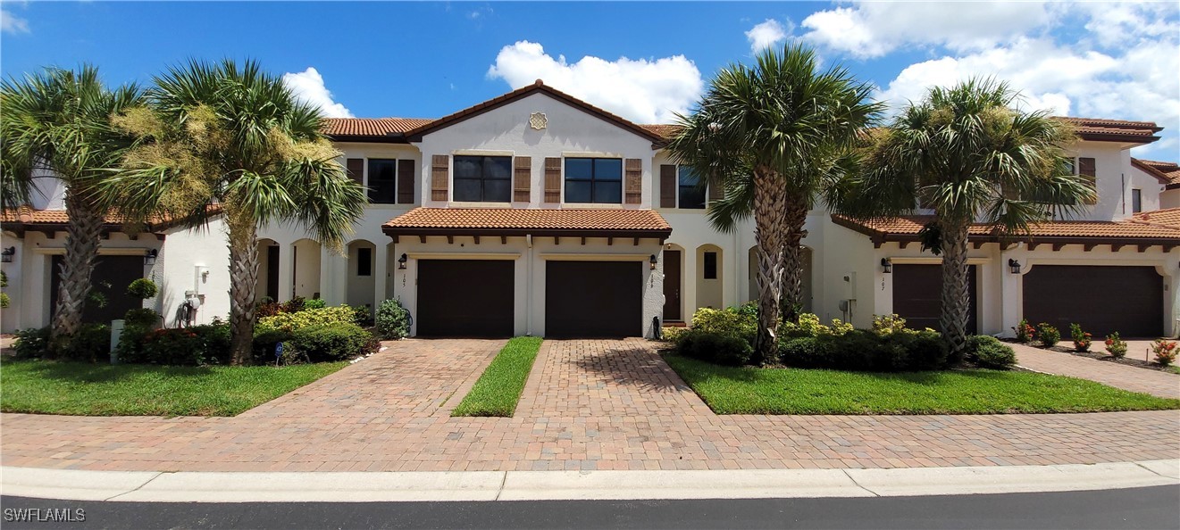 a front view of a house with a yard and garage