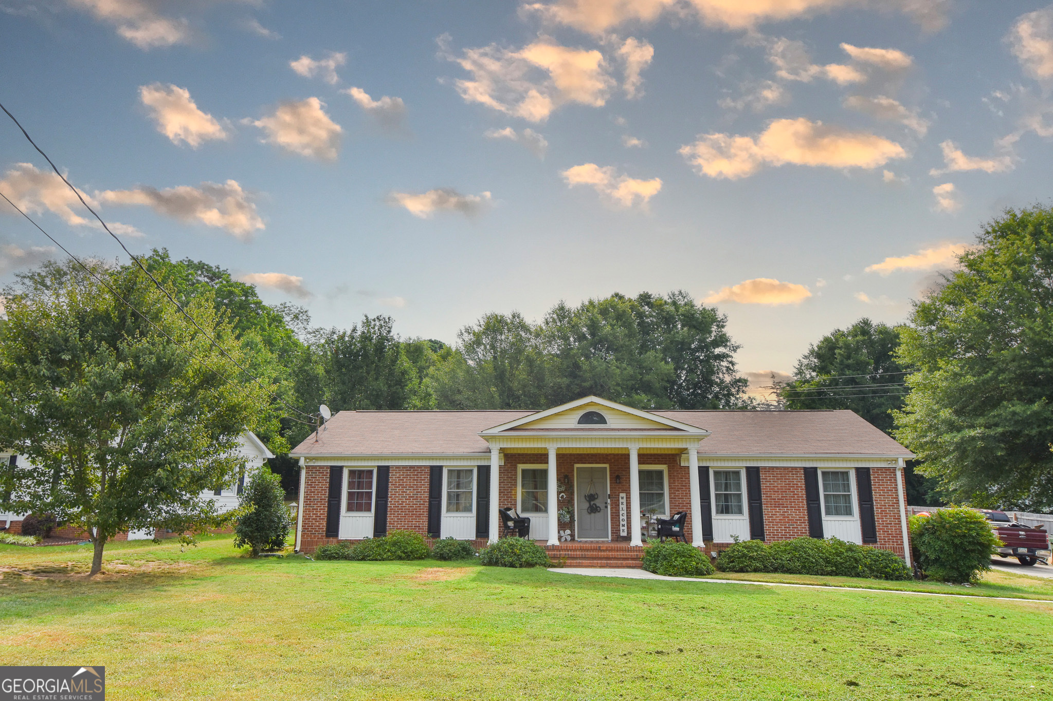 a front view of a house with a garden