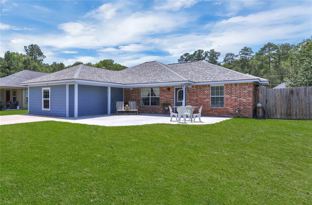 a front view of a house with yard patio and green space