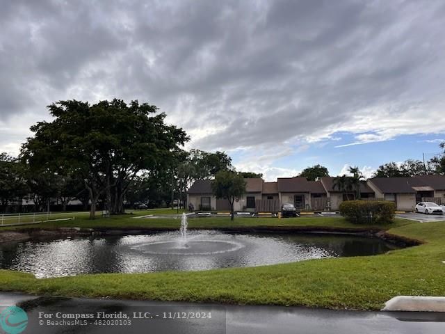 a view of swimming pool with a yard in the background