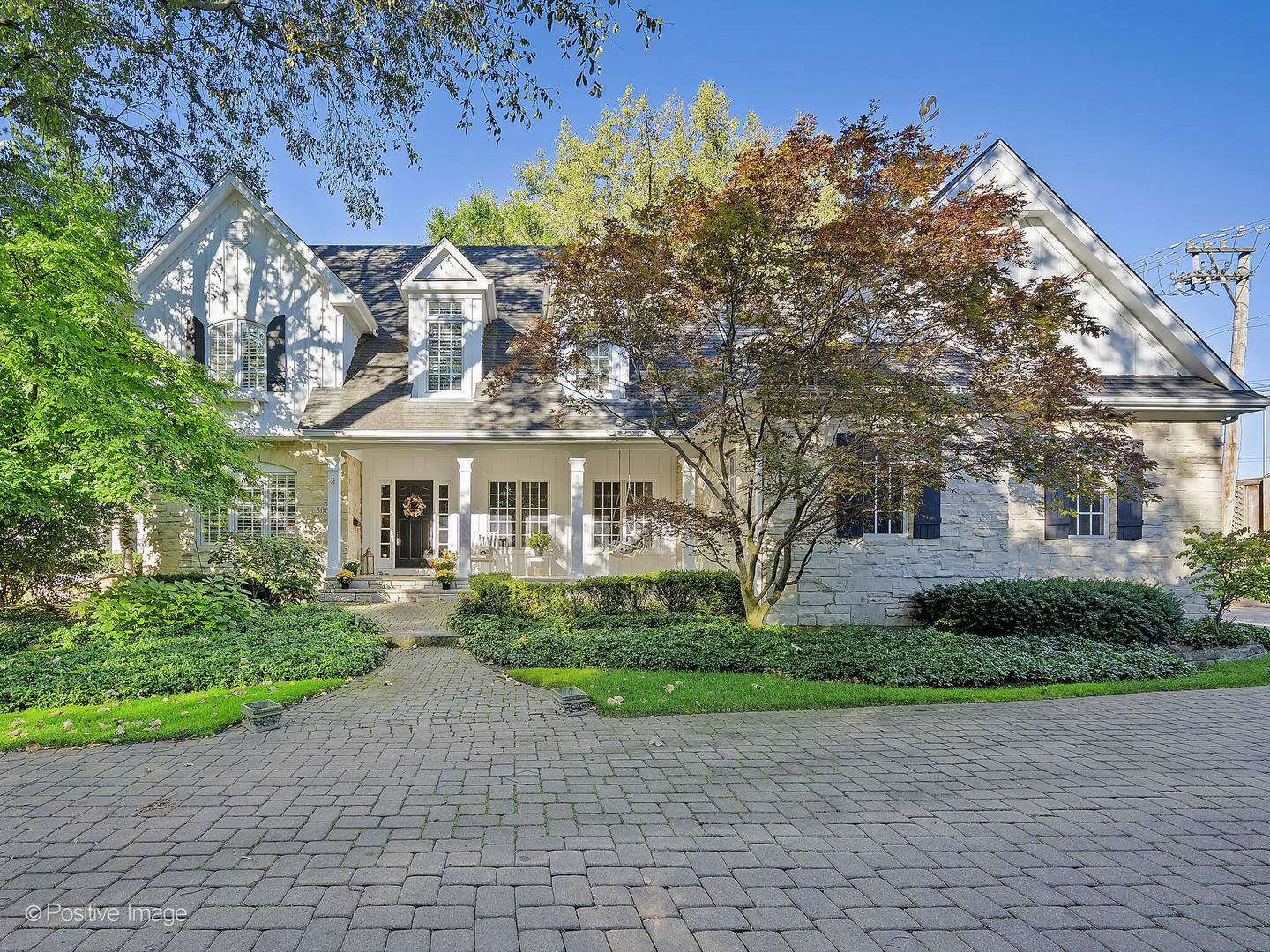 a view of a white house with a yard and plants