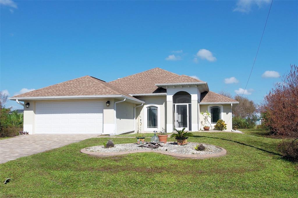 a front view of a house with yard and green space