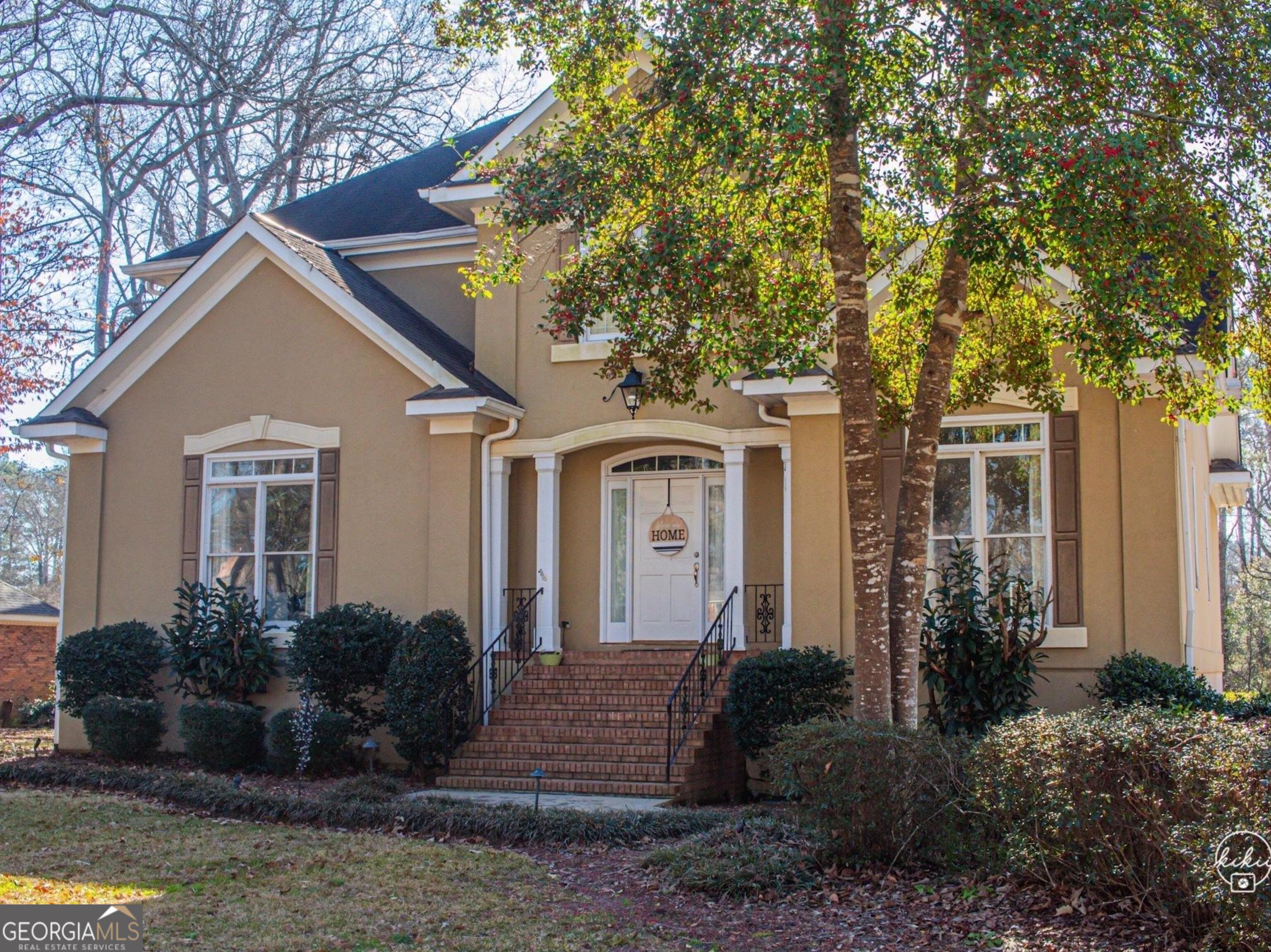 a front view of a house with garden