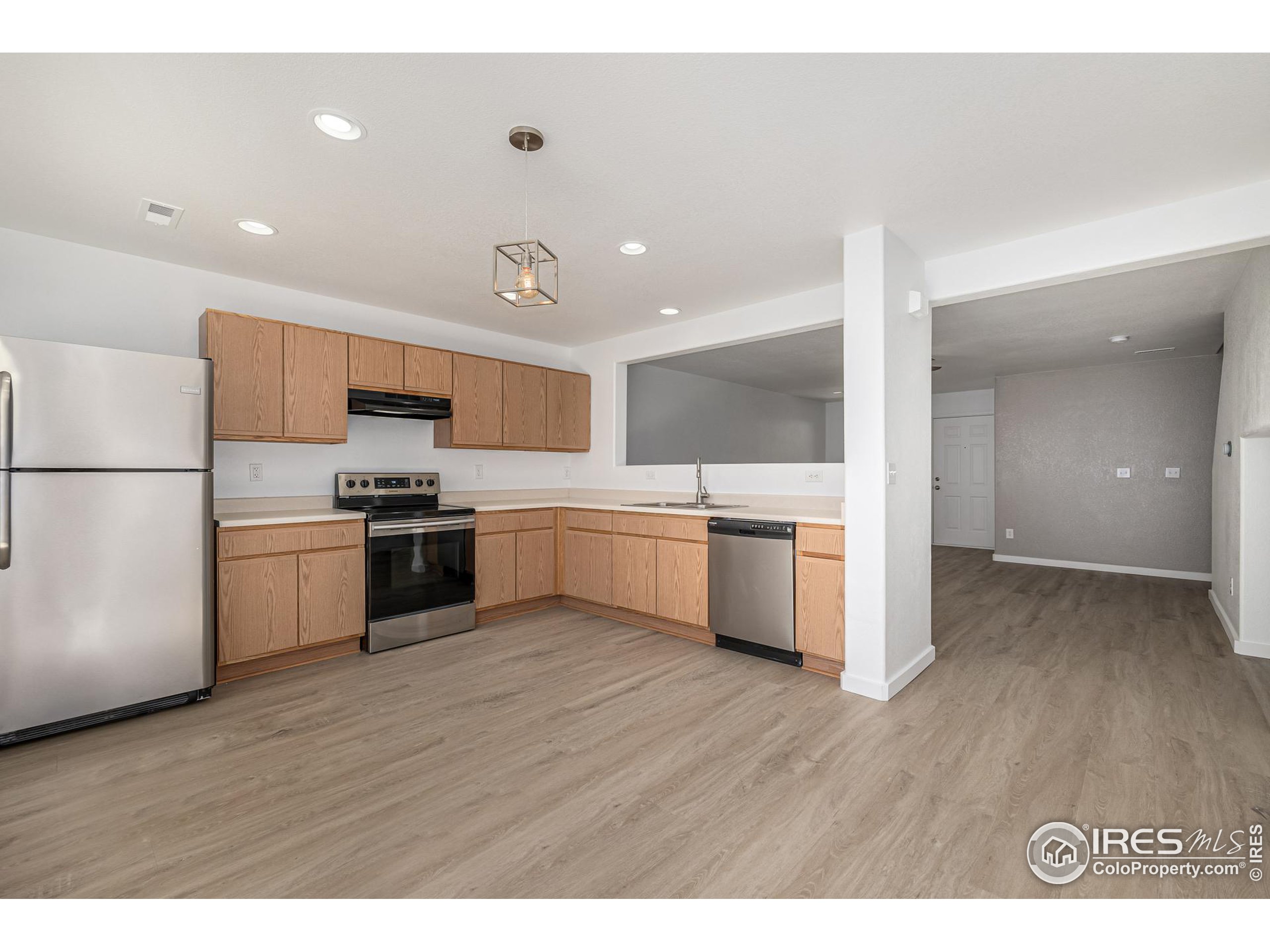 a kitchen with a sink stainless steel appliances and cabinets