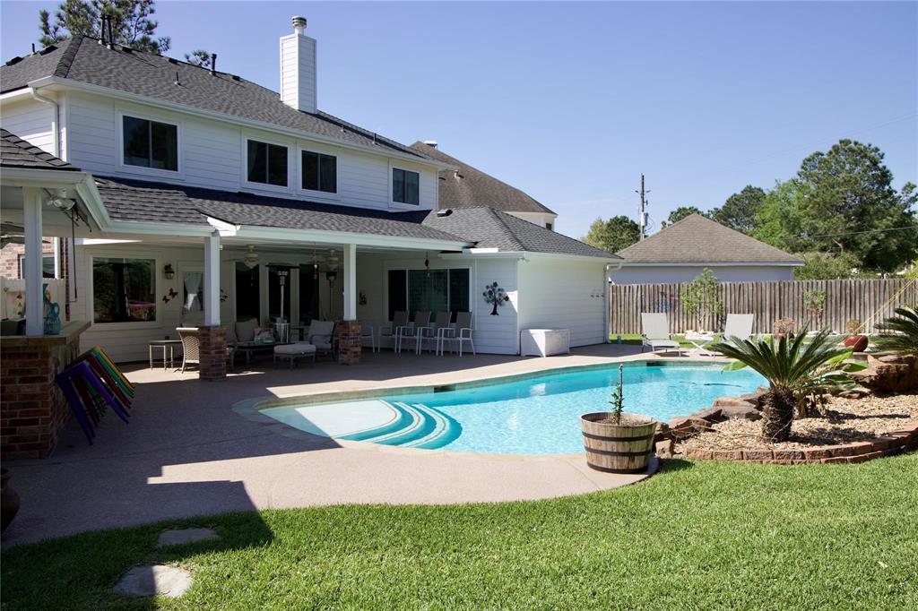 a view of a house with swimming pool and sitting area