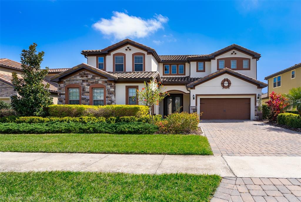 a front view of a house with a yard and garage