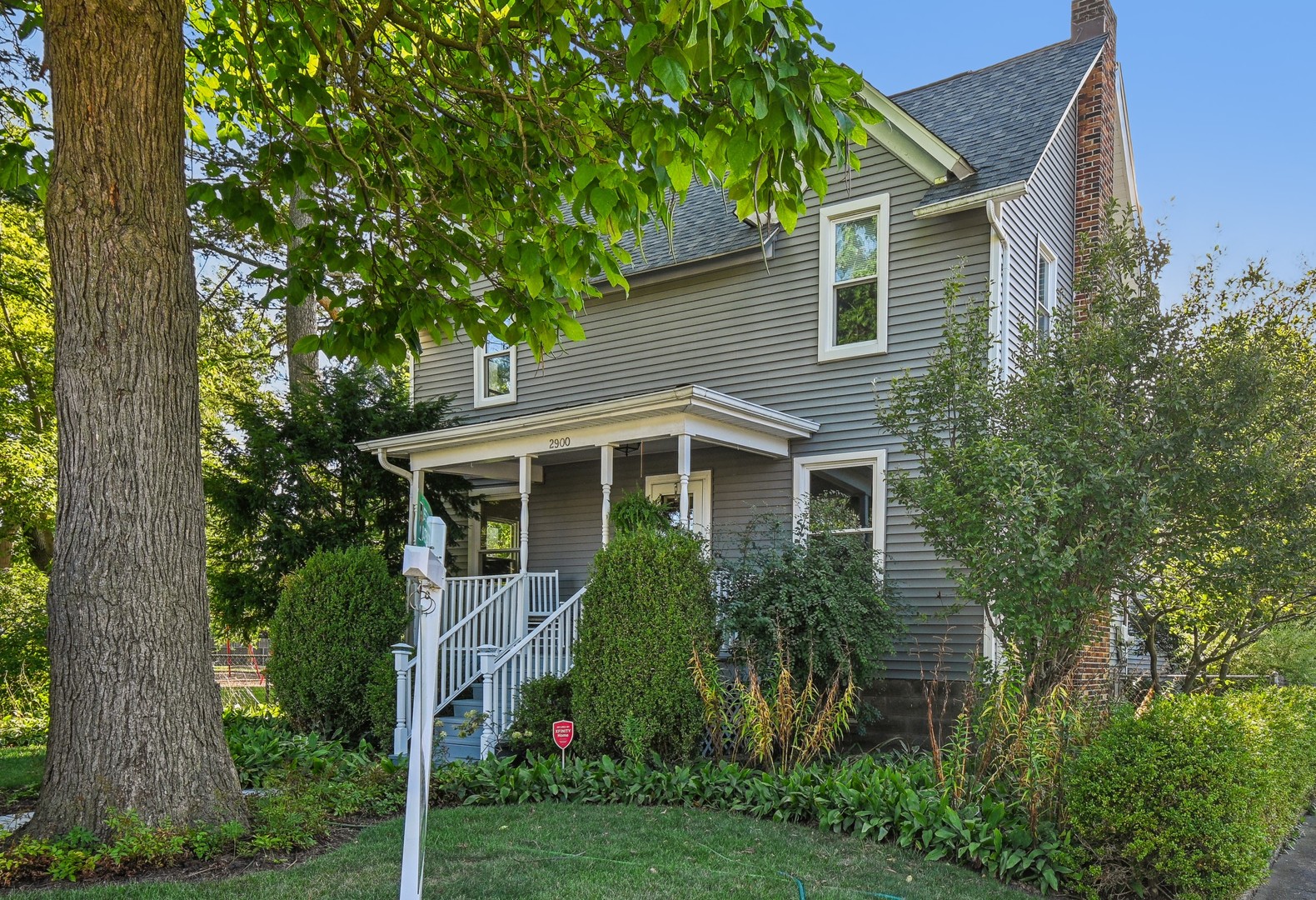 a front view of house with yard and green space