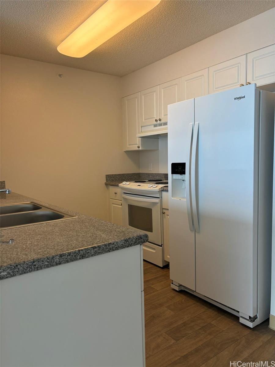 a kitchen with cabinets and stainless steel appliances