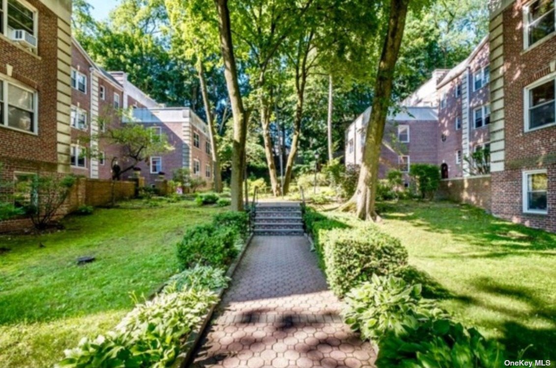 a view of a pathway both side of the house