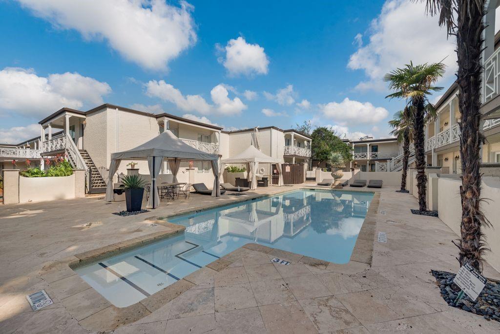 a view of a swimming pool with a patio