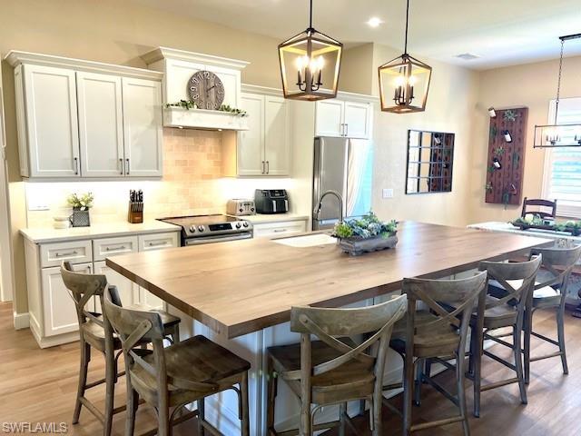 a kitchen with stainless steel appliances granite countertop a sink dishwasher and a dining table with chair