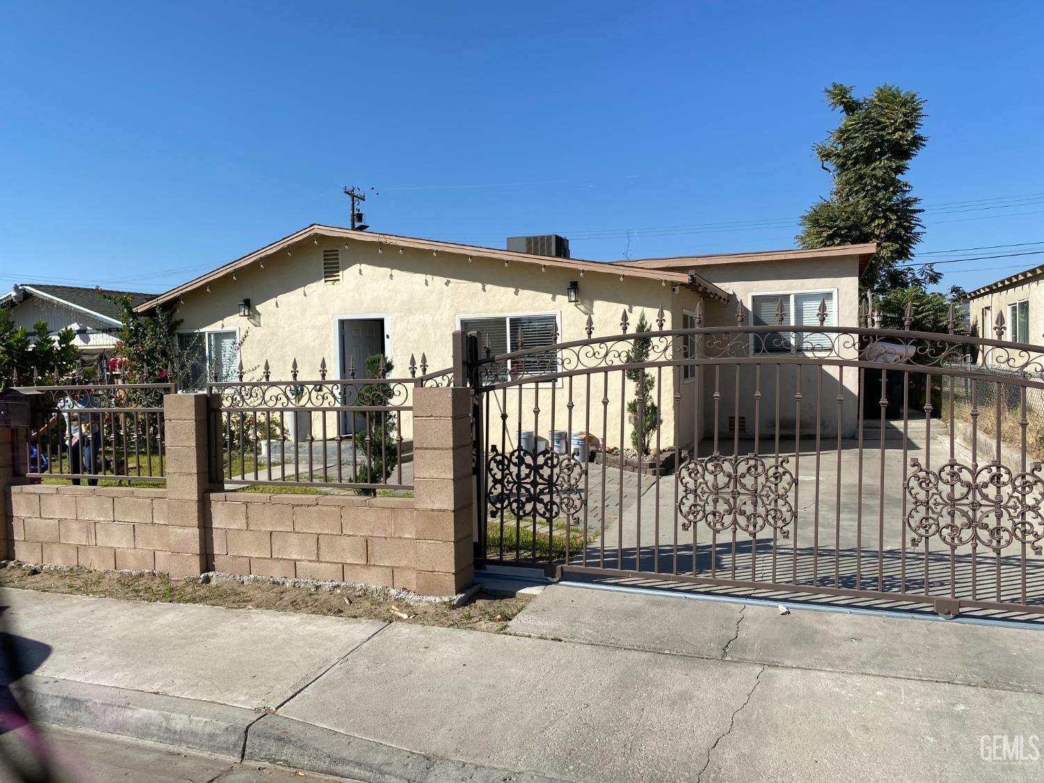 a front view of a house with a iron gate