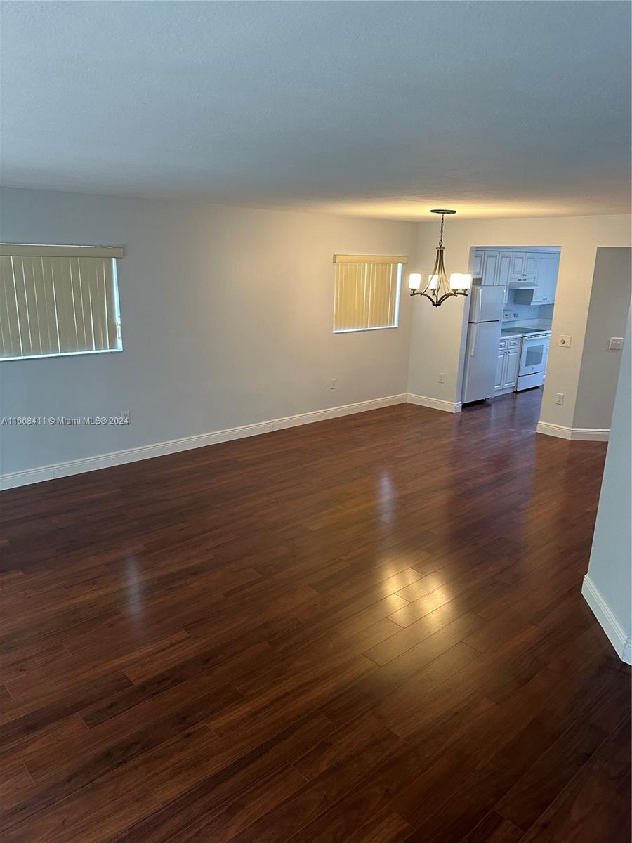 a view of a room with wooden floor and chair