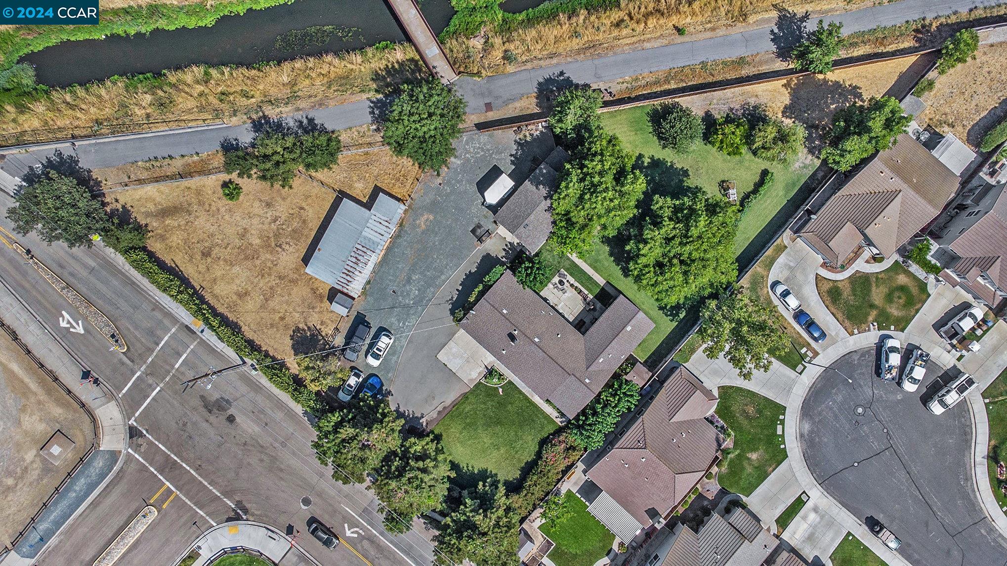 an aerial view of a house with a yard and a garden