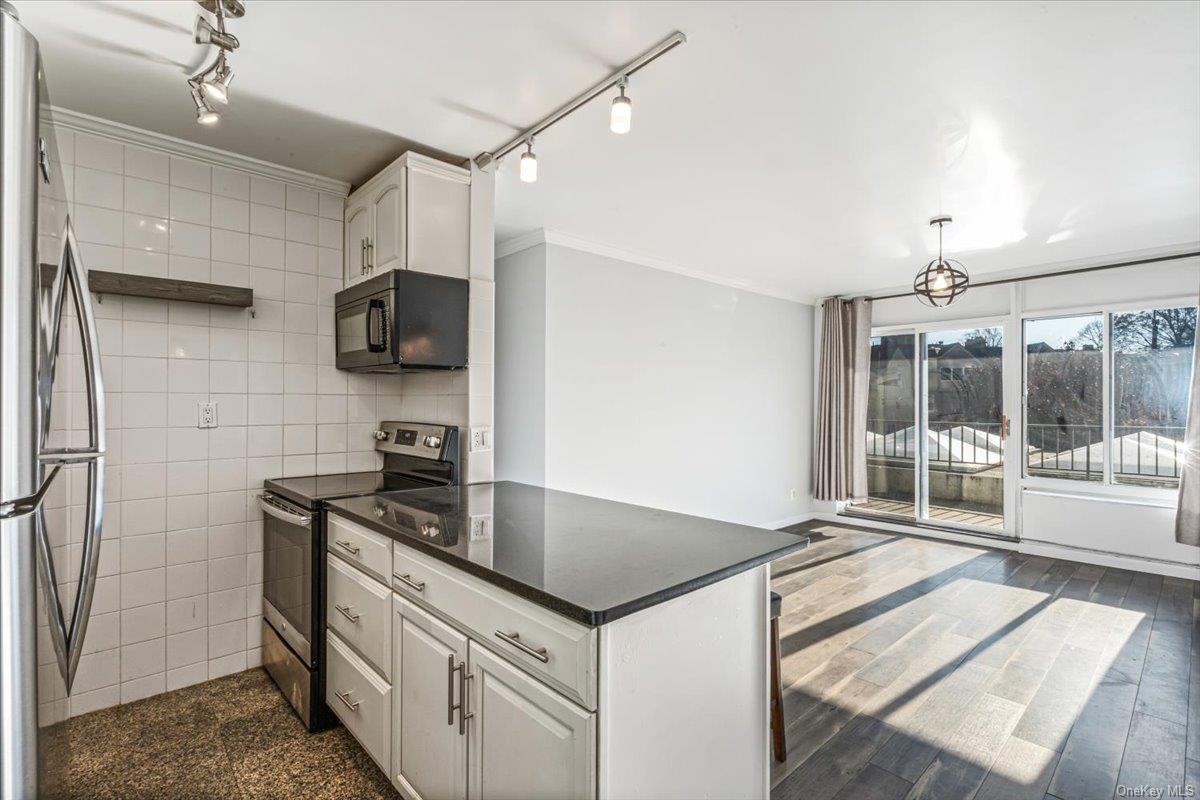 a kitchen that has a sink and a stove in it