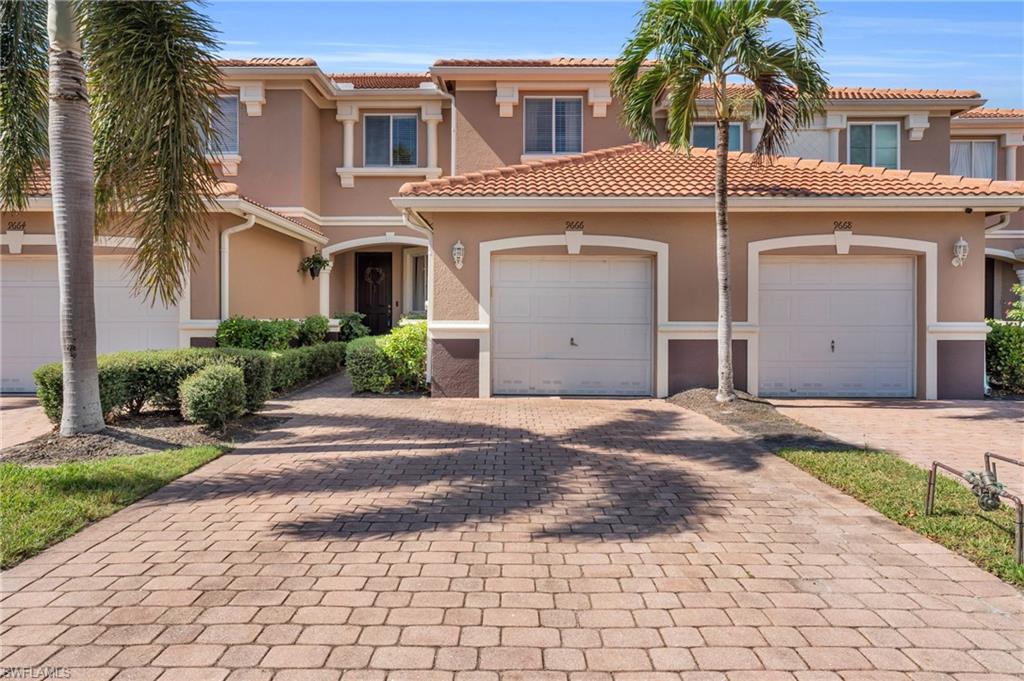 a front view of a house with a yard and garage