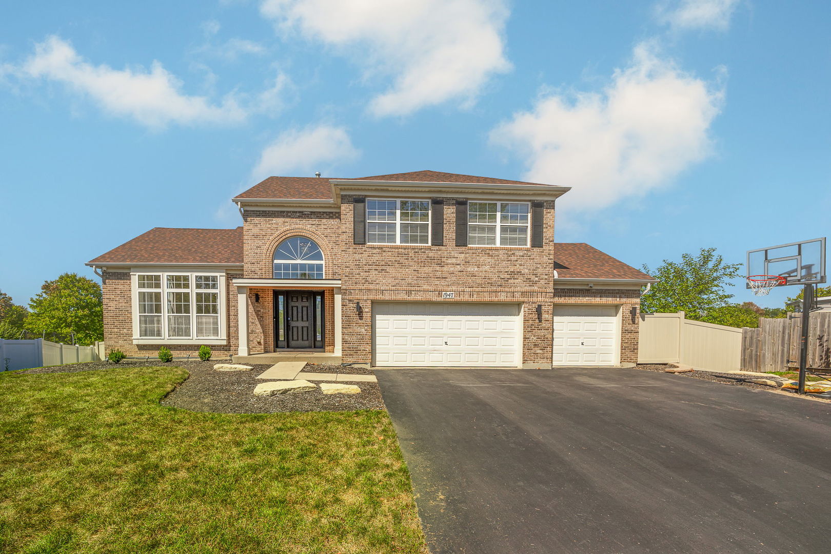 a front view of a house with a yard