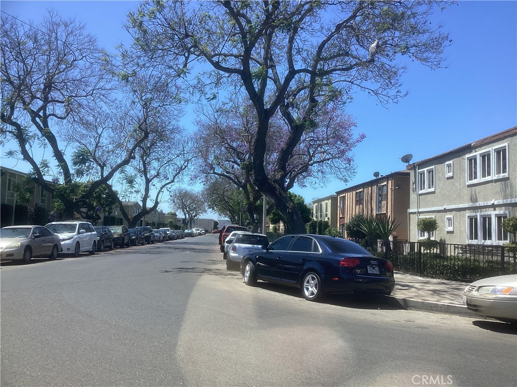 a view of street with parked cars