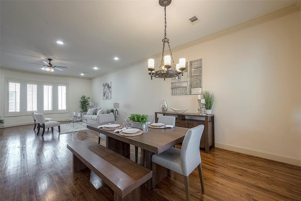 a view of a dining room with furniture wooden floor and chandelier