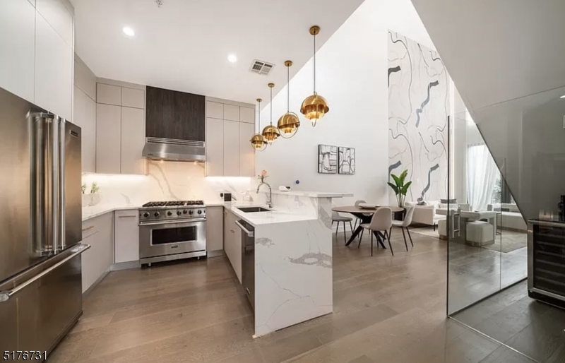 a kitchen with a sink appliances and cabinets