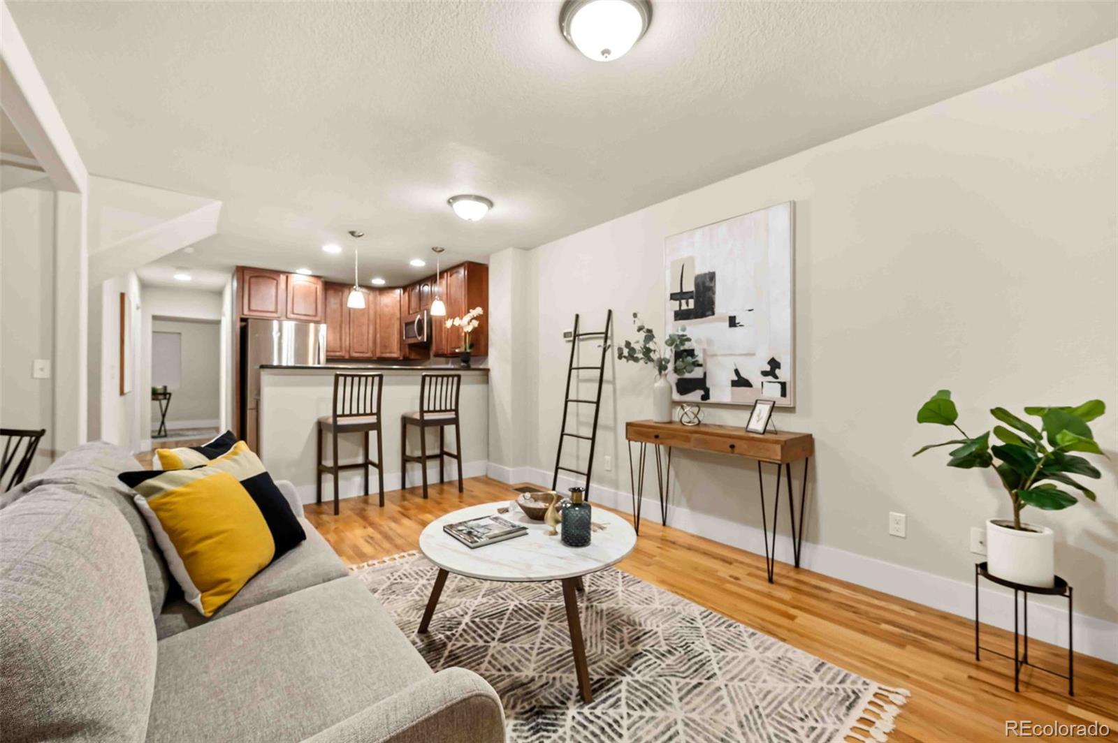 a living room with furniture kitchen and a table