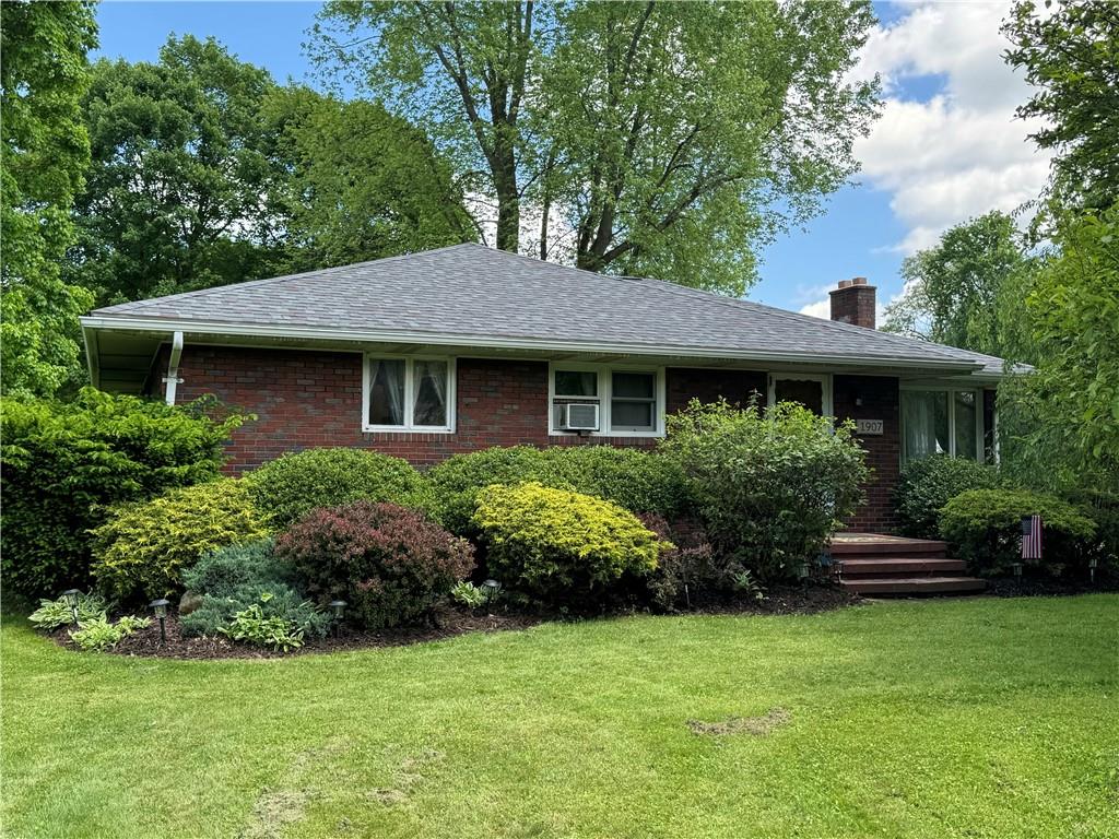 a front view of a house with a garden