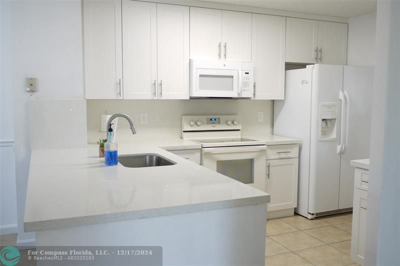 a kitchen with stainless steel appliances a white cabinet and a sink