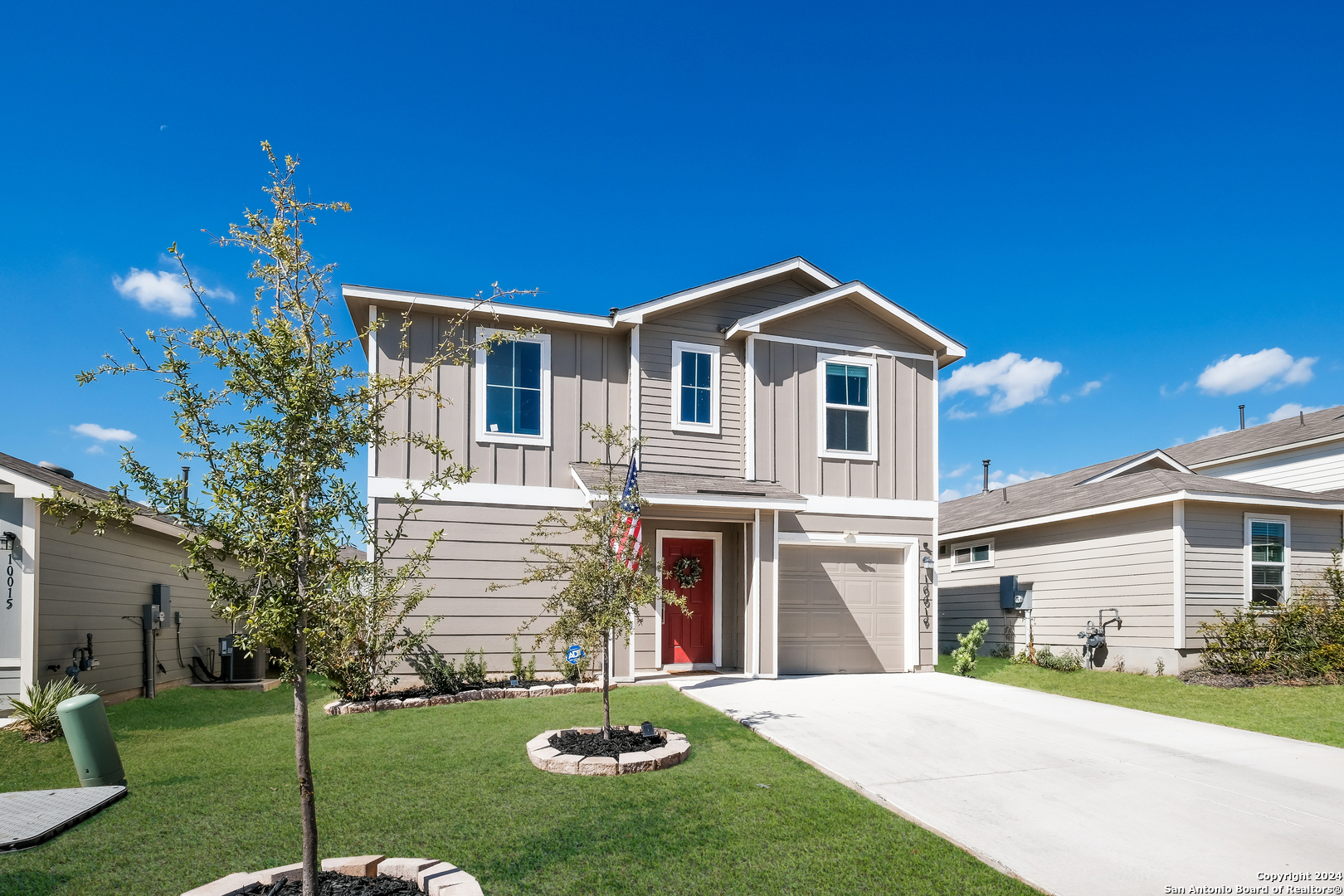 a front view of a house with a yard and garage