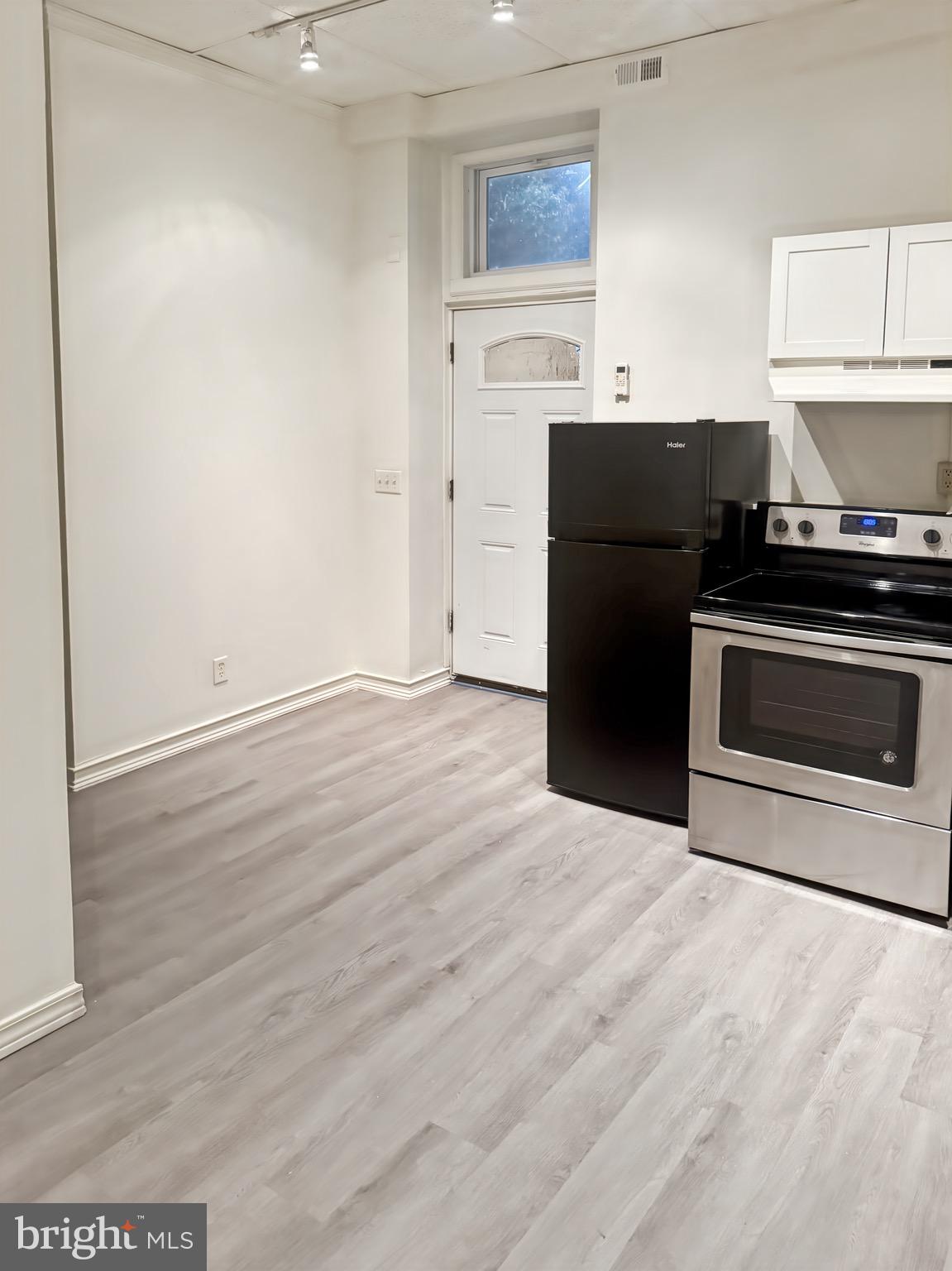 a kitchen with granite countertop a stove and a refrigerator