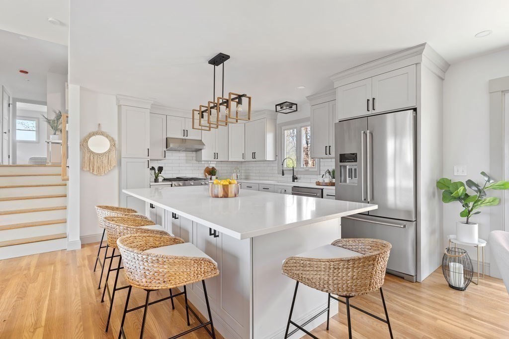 a kitchen with stainless steel appliances a sink and a refrigerator