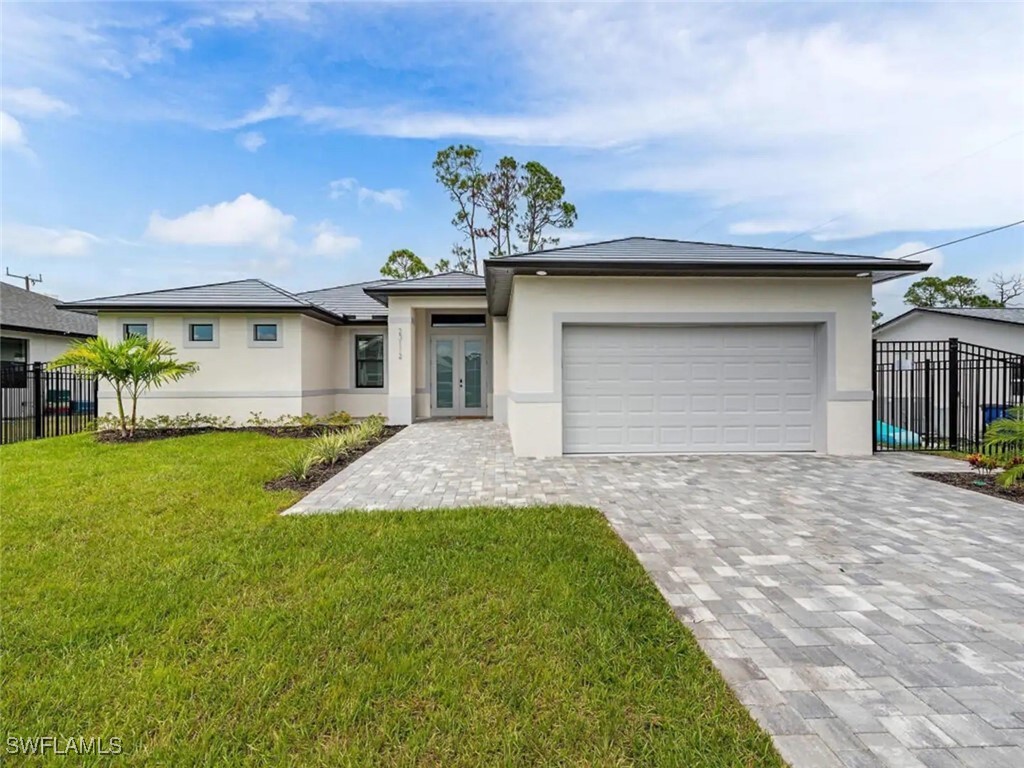 a front view of a house with a yard and garage