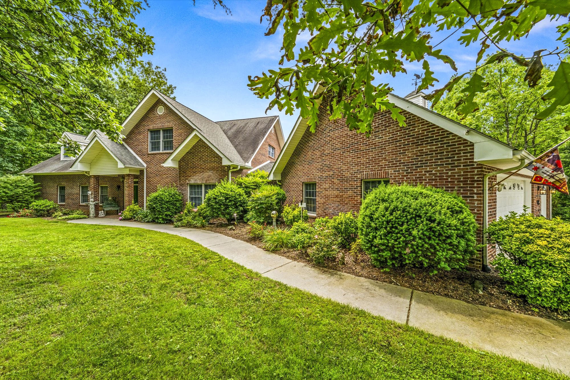 a front view of a house with a garden