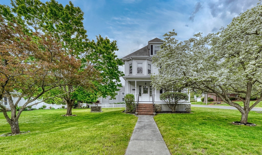 a front view of a house with garden