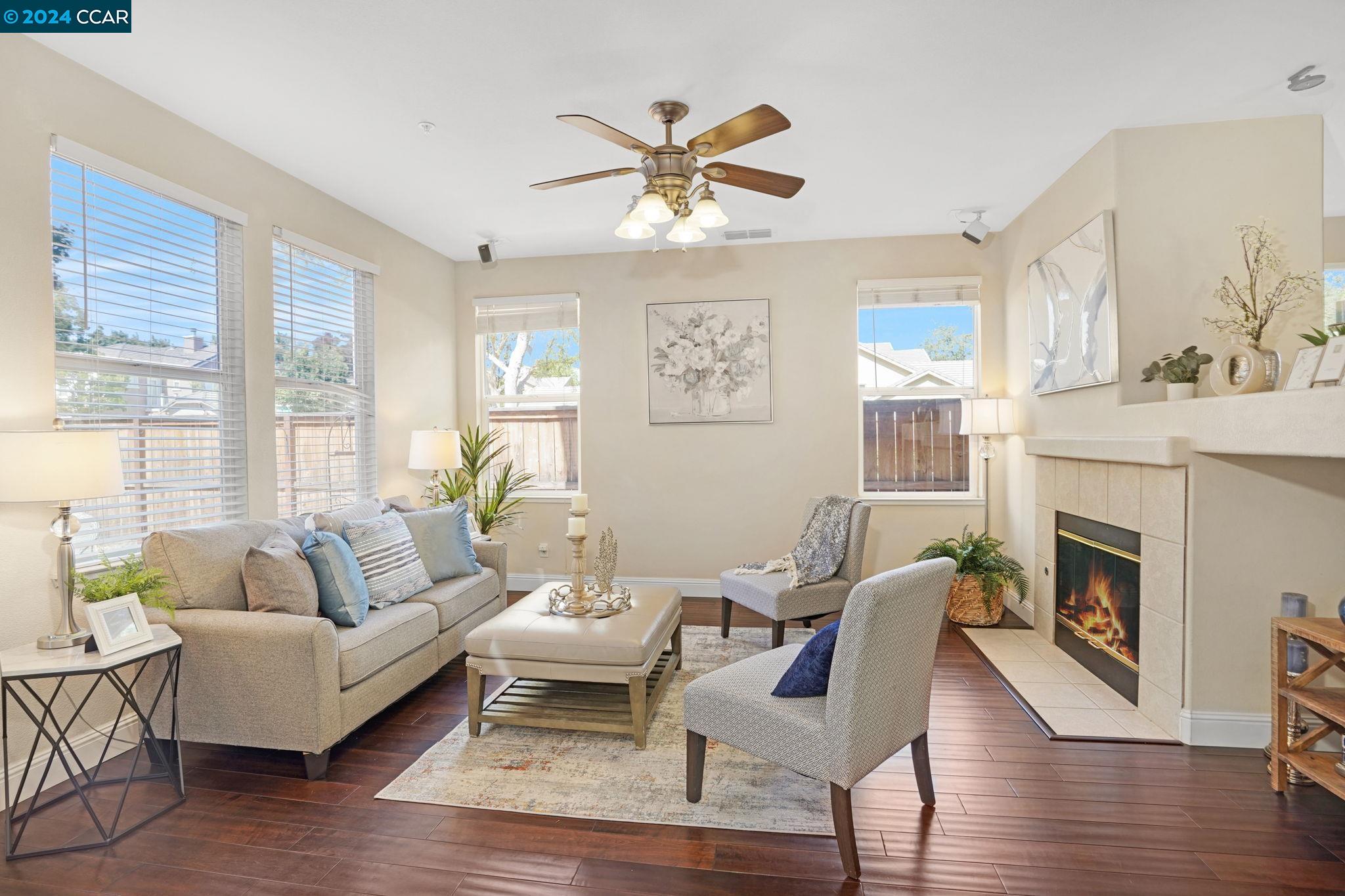 a living room with furniture a fireplace and a large window