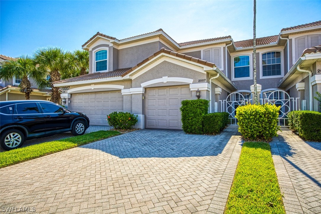 a front view of a house with a yard and garage