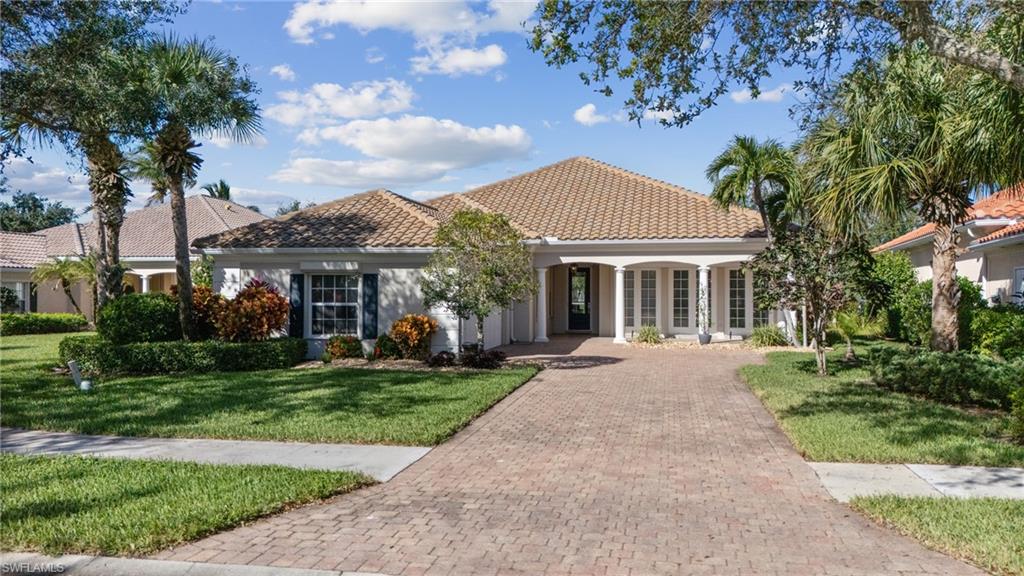 Mediterranean / spanish house featuring covered porch and a front yard