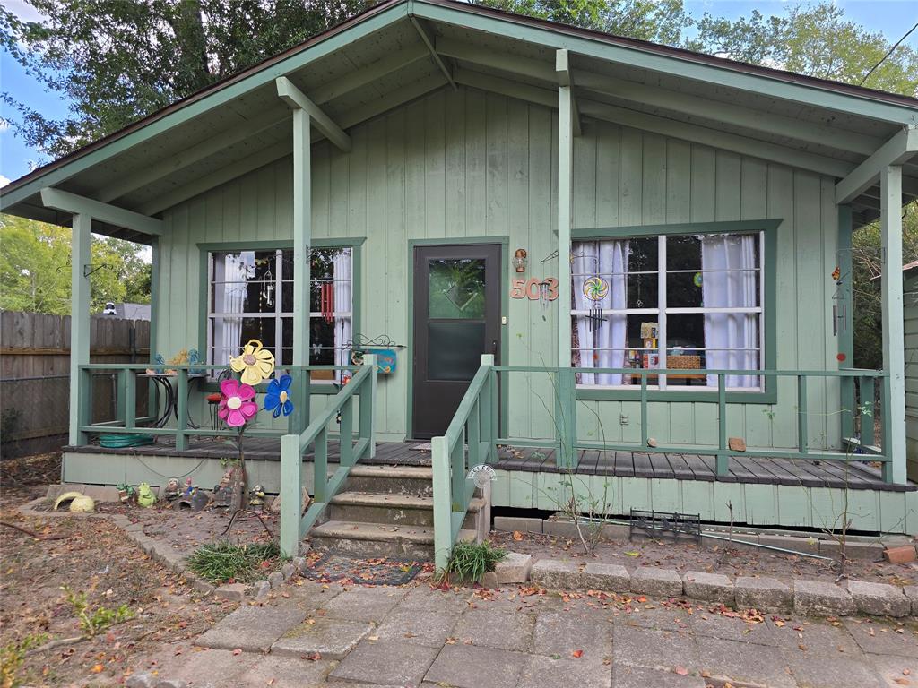 a view of a house with a small yard and a large window