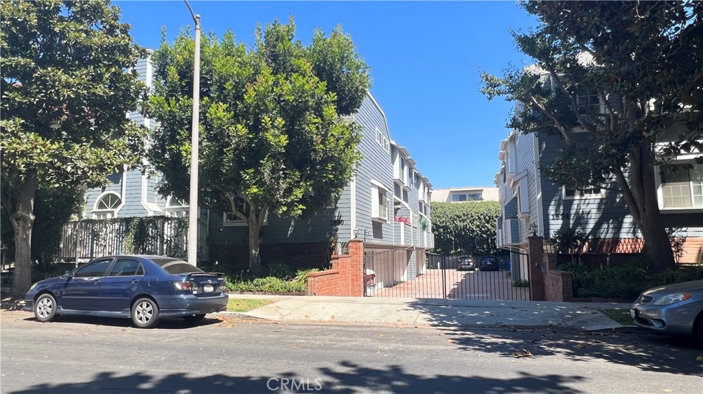 a view of a street that has couple of cars parked on the side of the road