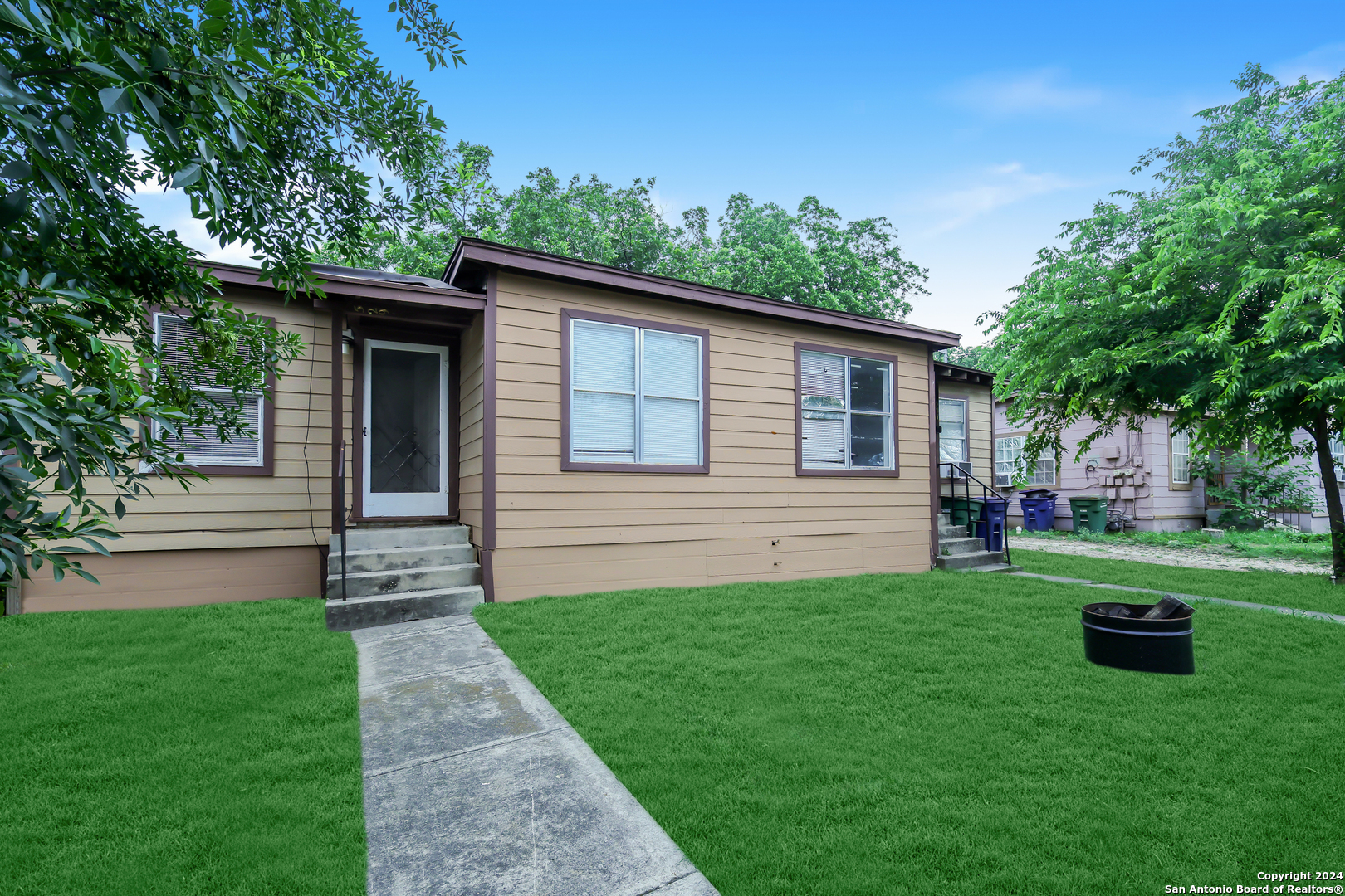 a front view of a house with garden