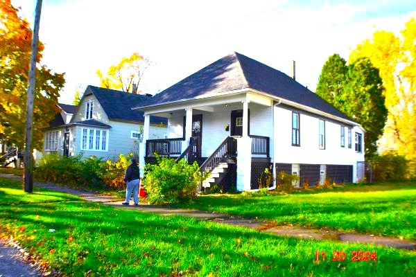 a front view of a house with garden and porch