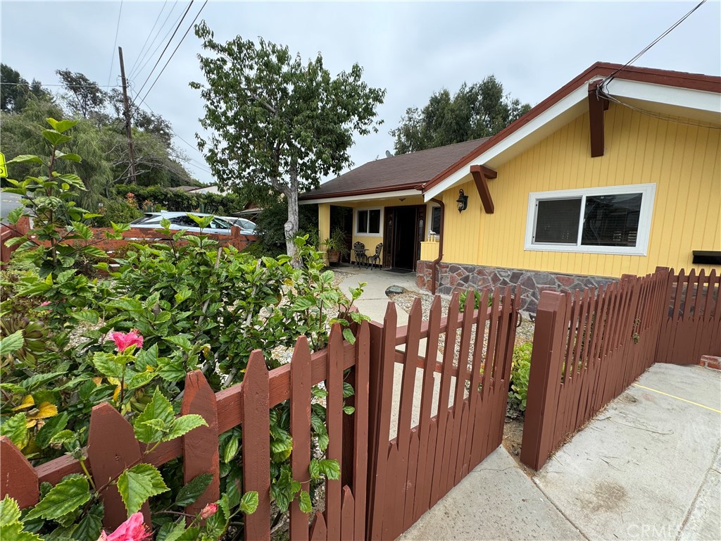 a view of a house with wooden fence