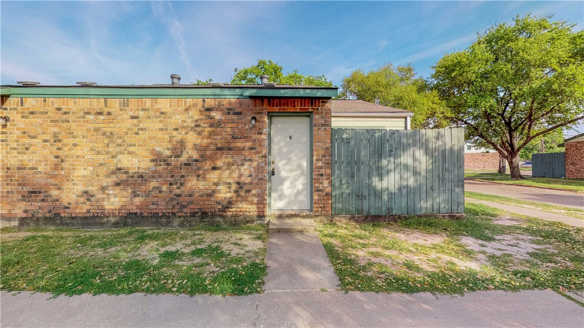 a view of backyard with wooden fence