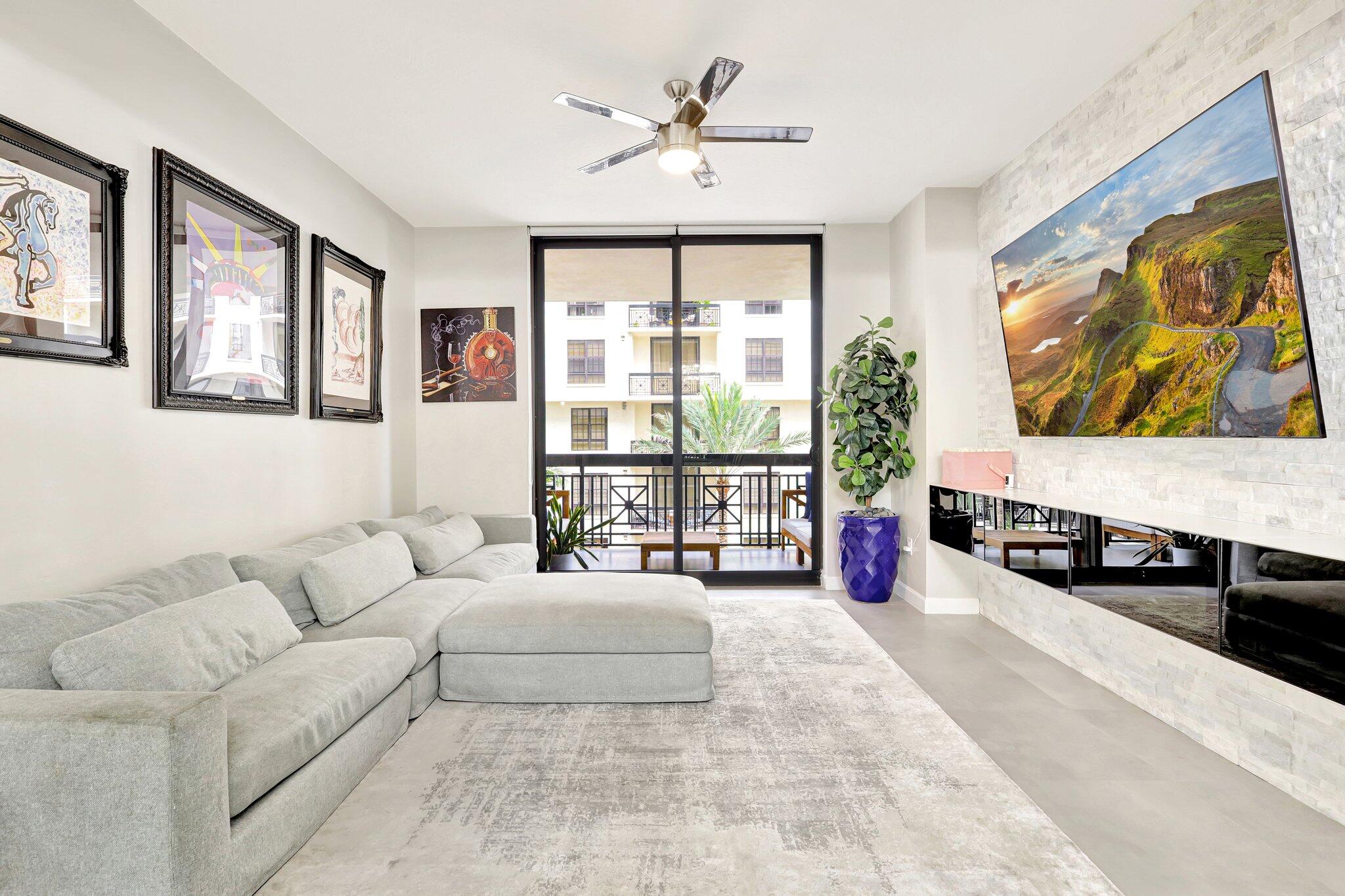 a living room with furniture and a floor to ceiling window