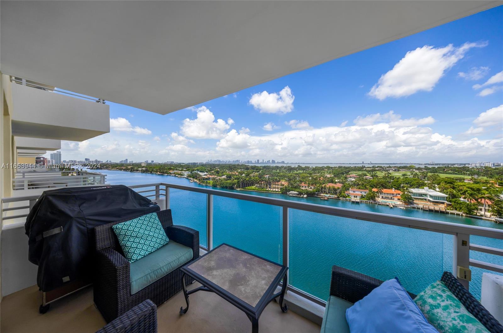 a view of a balcony with furniture and a floor to ceiling window