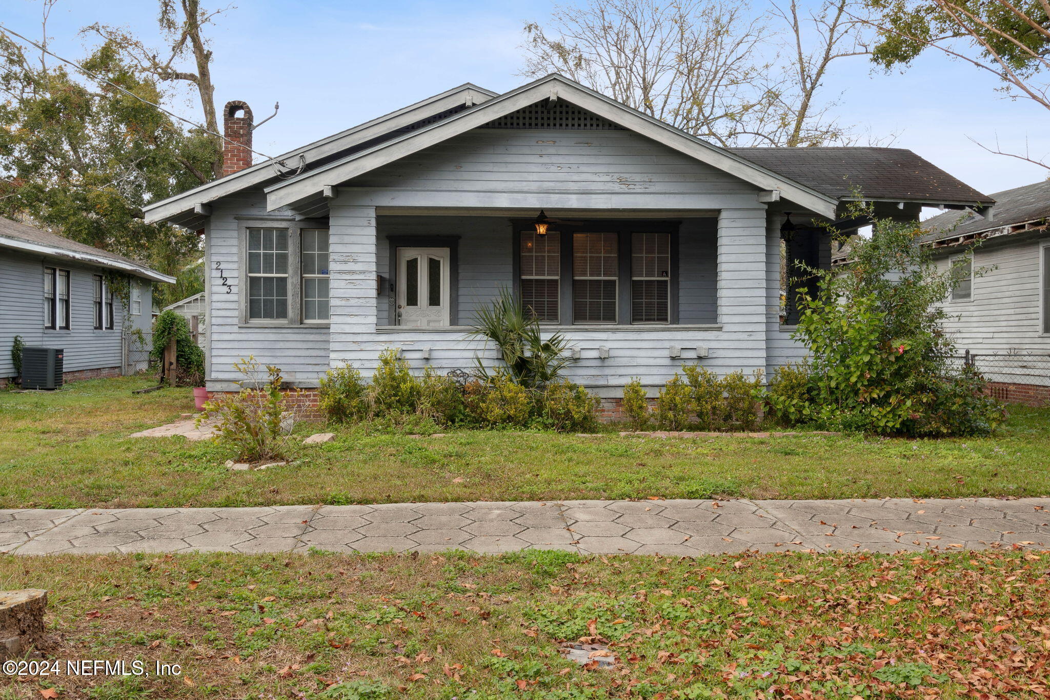 a front view of house with yard and green space