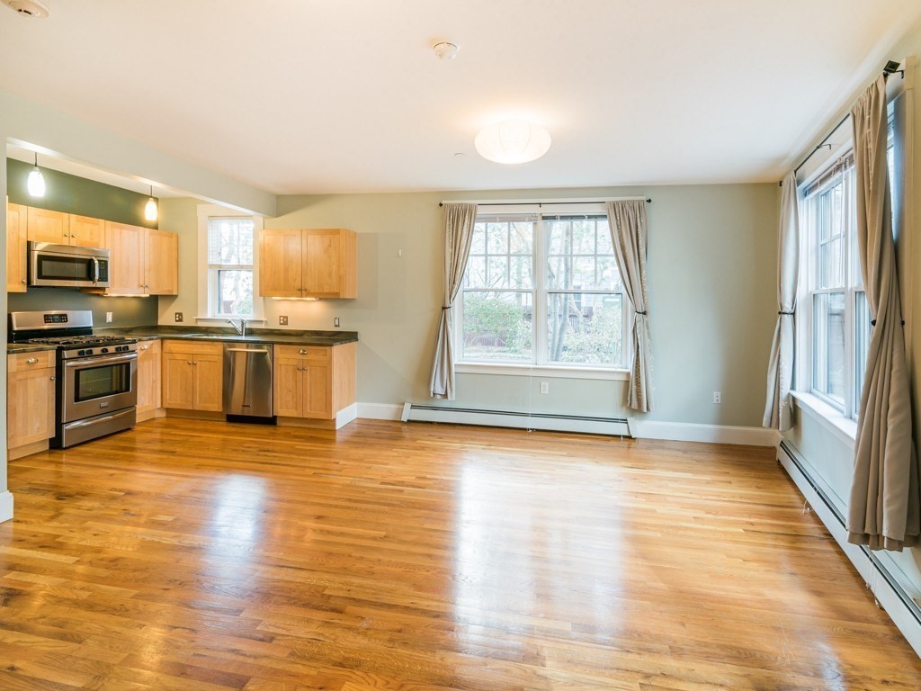 a view of a kitchen next to a window