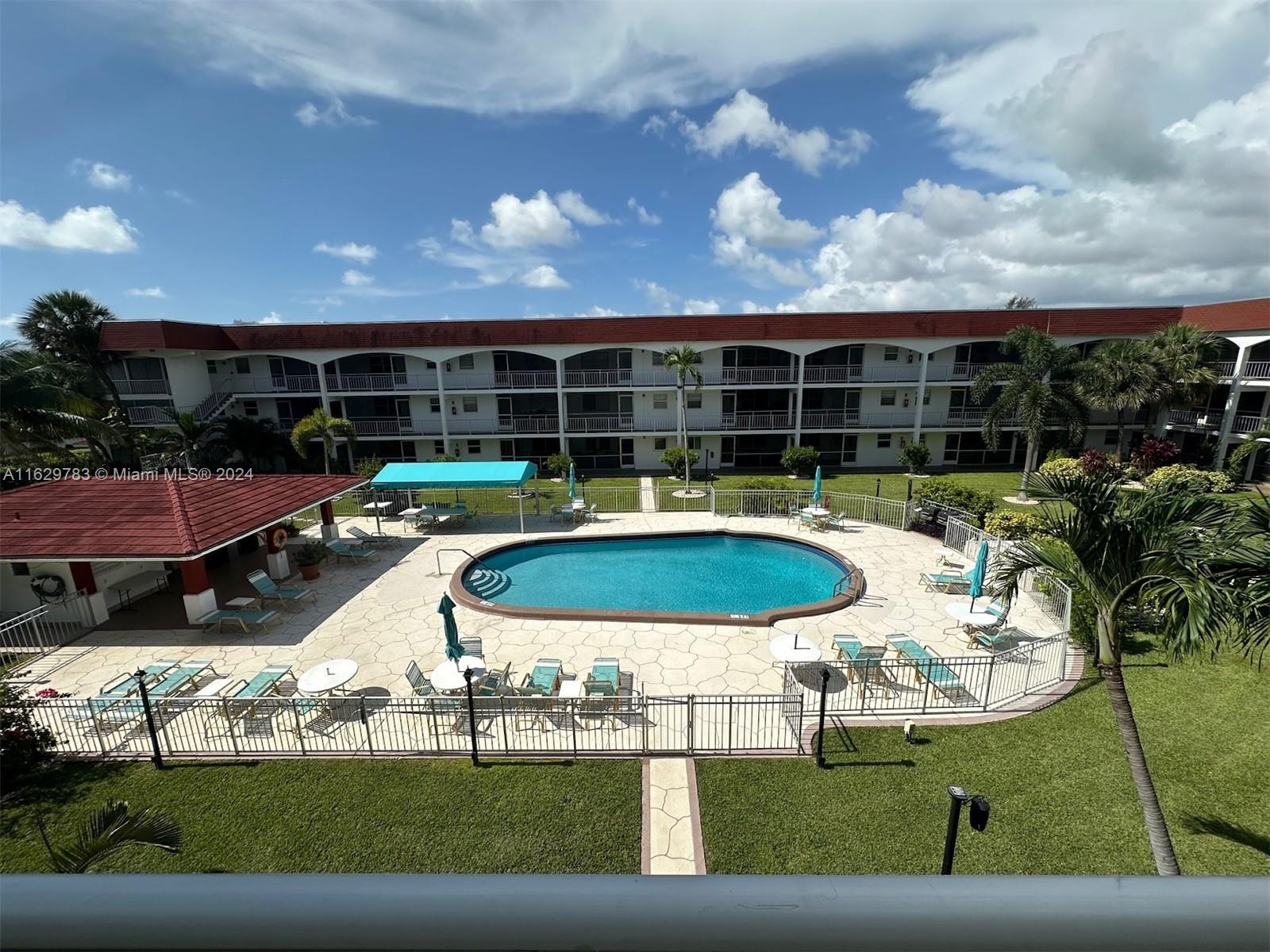 a view of a swimming pool with seating space