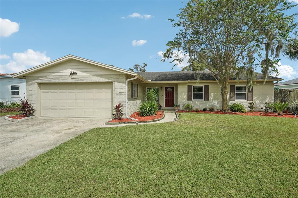 a front view of a house with a yard and garage