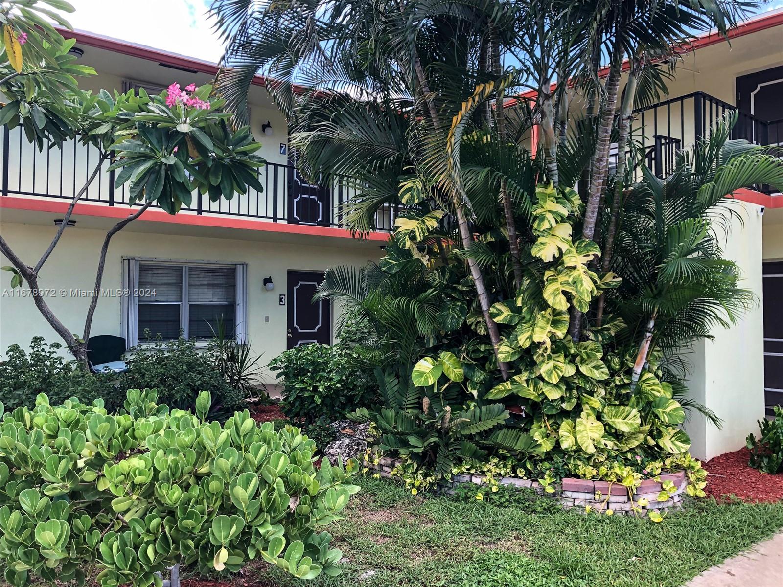 a view of a house with a flower garden