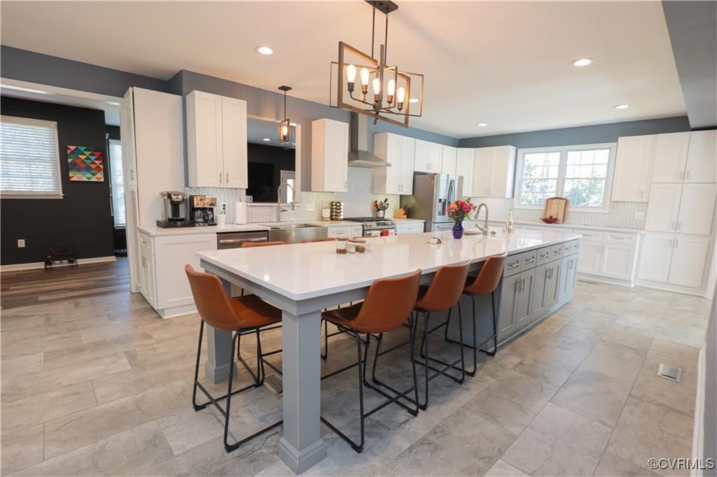 a large kitchen with a table and chairs